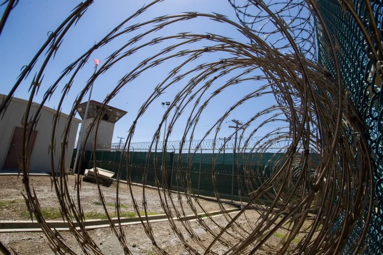 FILE - In this Wednesday, April 17, 2019 file photo reviewed by U.S. military officials, the control tower is seen through the razor wire inside the Camp VI detention facility in Guantanamo Bay Naval Base, Cuba.