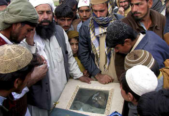Villagers look at the body of a victim of a U.S. drone attack in December 2010, in a Pakistani tribal area along the Afghanistan border.