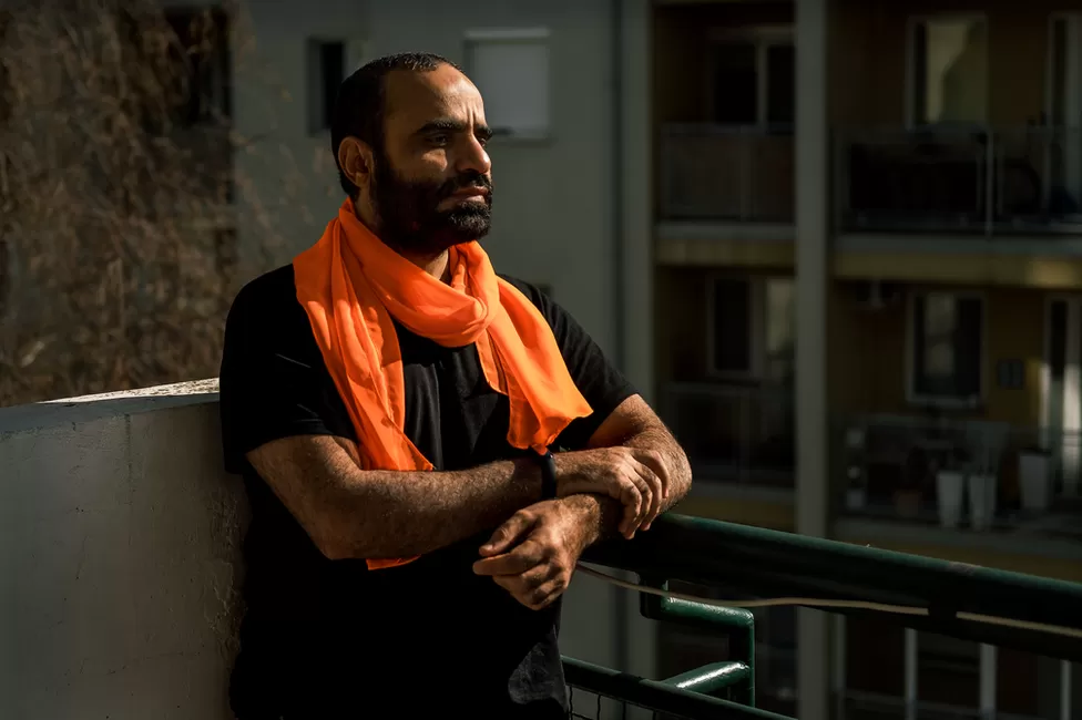 Mansoor Adayfi on the balcony of his Belgrade apartment. "Guantanamo follows you everywhere you go," he said.
