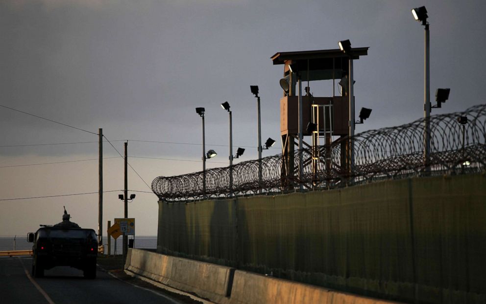 PHOTO: In this March 30, 2010 photo reviewed by the U.S. military, a U.S. trooper stands in the turret of a vehicle with a machine gun, left, as a guard looks out from a tower at the detention facility on Guantanamo Bay U.S. Naval Base in Cuba.
