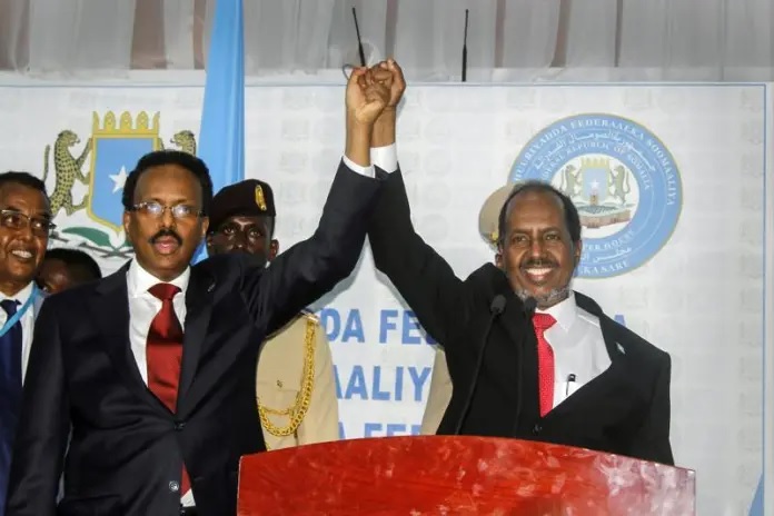 Hassan Sheikh Mohamud, a la derecha, celebra su victoria electoral con el actual lder Mohamed Abdullahi Mohamed, a la izquierda, en el campamento militar de Halane en Mogadishu, Somalia, el domingo 15 de mayo de 2022. El expresidente Mohamud, quien fue destituido del poder por votacin en 2017, ha ha regresado a la oficina principal de la nacin despus de derrotar al lder en ejercicio en una contienda prolongada decidida por los legisladores en una tercera ronda de votacin el domingo por la noche. (Foto AP/Farah Abdi Warsameh)